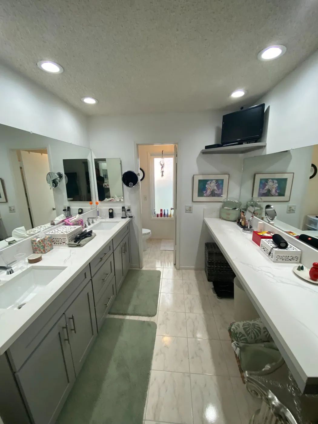Bright residential bathroom with a double vanity, two sinks, and wall mirrors