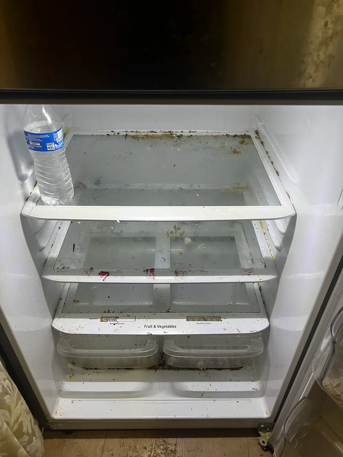 Soiled refrigerator interior before a StudioScrubz deep cleaning